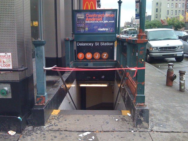 This entrance, along with four others to the J/M/Z/F stop on Essex and Delancey were taped up, but the southwest stairwell was wide open, where we found a guy with a Dave Matthews Caravan shirt on trying to make the last train. The Lord works in mysterious ways.